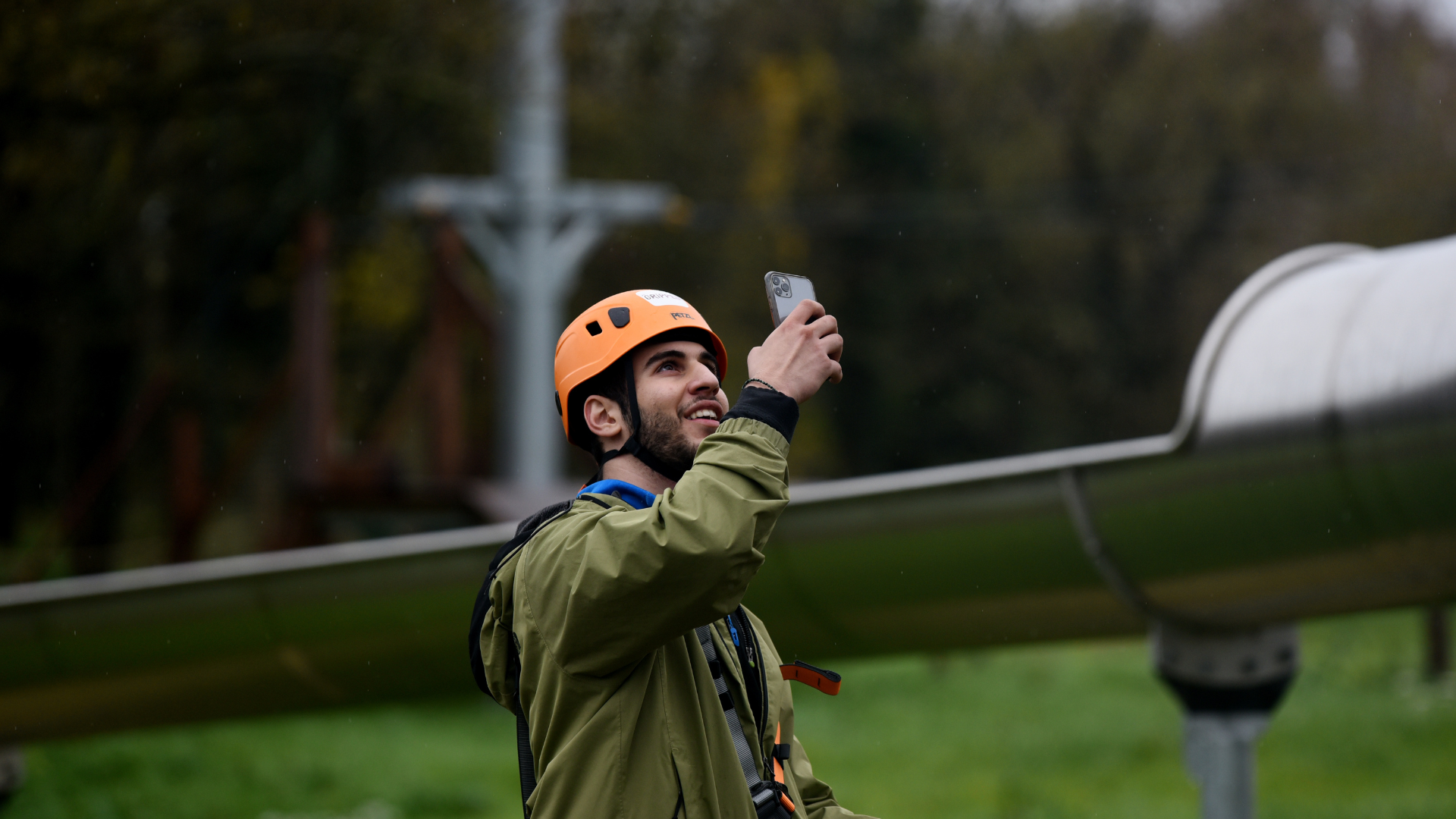 Content creator filming high ropes and zip line tower at Gripped West London with helmet for immersive influencer content
